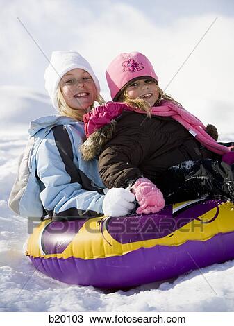 Stock Image - playing in the snow. Fotosearch
