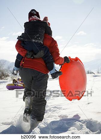 Stock Photograph - playing in the snow. Fotosearch
