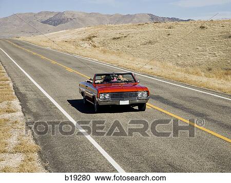 red car driving down the road View Large Photo Image Stock Image - red car driving down the road. Fotosearch