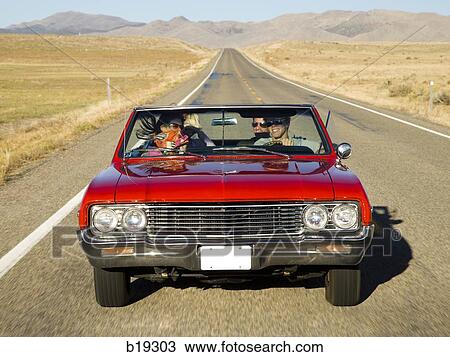 red car driving down the road View Large Photo Image Stock Image - red car driving down the road. Fotosearch