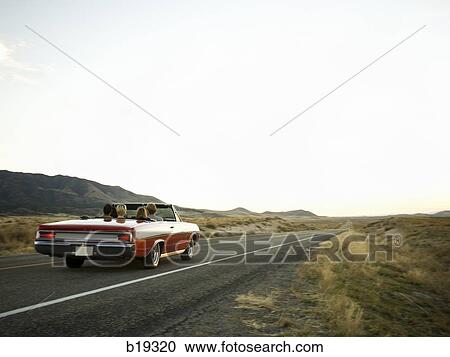 red car driving down the road View Large Photo Image Stock Image - red car driving down the road. Fotosearch