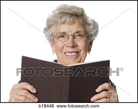 Stock Photo - Senior woman reading a book.. Fotosearch