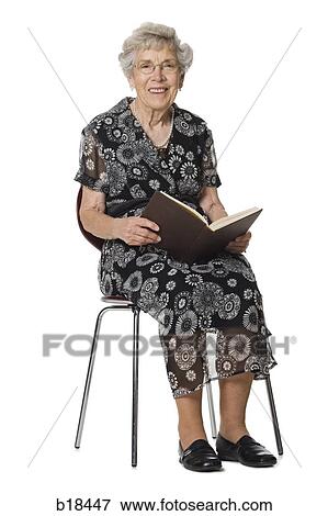 Senior woman sitting and reading a book. View Large Photo Image Stock Photo - Senior woman sitting and reading a book.. Fotosearch