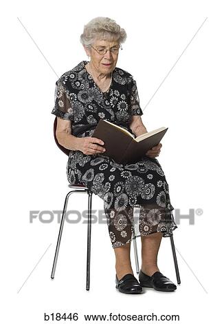 Senior woman sitting and reading a book. View Large Photo Image Stock Photograph - Senior woman sitting and reading a book.. Fotosearch