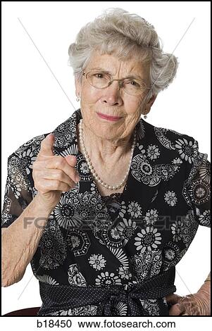 Senior woman with glasses looking sternly at camera. View Large Photo Image Stock Image - Senior woman with glasses looking sternly at camera.. Fotosearch