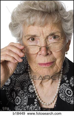 Senior woman with glasses looking sternly at camera. View Large Photo Image Stock Photo - Senior woman with glasses looking sternly at camera.. Fotosearch