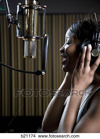 Picture - singing in a recording studio. Fotosearch