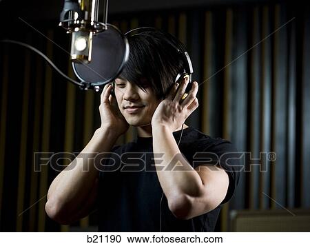 Stock Image - singing in a recording studio. Fotosearch