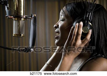 Stock Photography - singing in a recording studio. Fotosearch