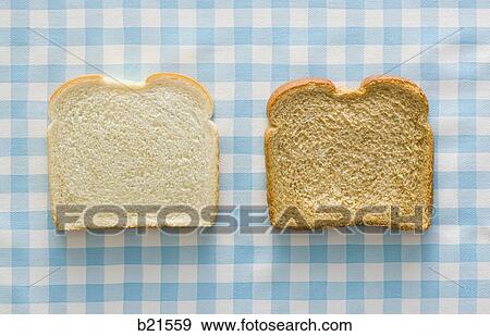 Stock Photo - slice of white bread and slice of wheat bread. Fotosearch