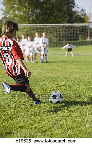soccer player kicking a ball View Large Photo Image Stock Photography - soccer player kicking a ball. Fotosearch