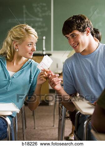 Students passing notes in a classroom. View Large Photo Image Stock Photograph - Students passing notes in a classroom.. Fotosearch