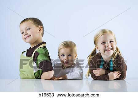 three children in aprons View Large Photo Image Stock Image - three children in aprons. Fotosearch
