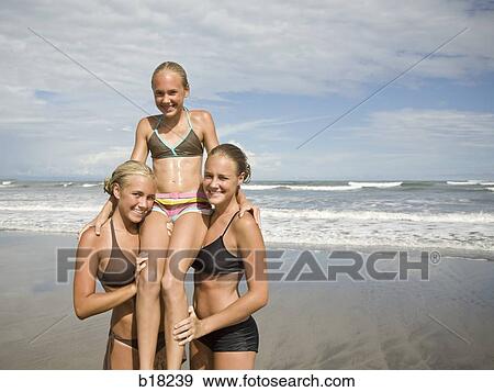 Stock Photo - Three girls on the beach.. Fotosearch