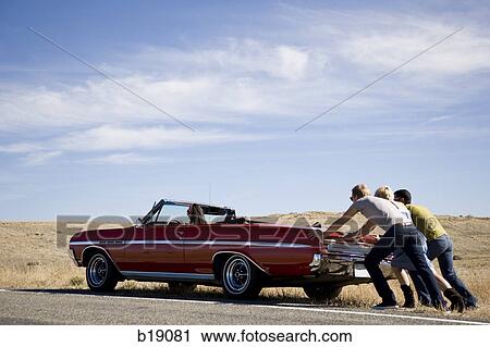 three people pushing a red convertible. View Large Photo Image Stock Image - three people pushing a red convertible.. Fotosearch