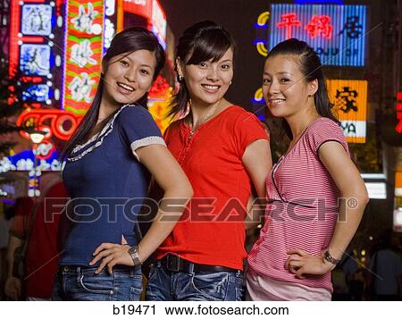 Stock Image - three woman on the street. Fotosearch