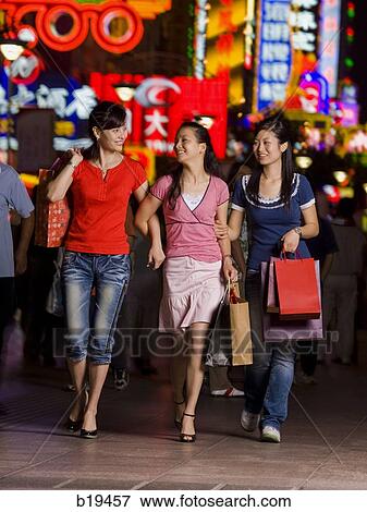 Stock Photo - three woman shopping. Fotosearch