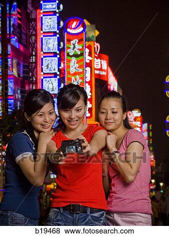 three woman with a camera View Large Photo Image Stock Photo - three woman with a camera. Fotosearch
