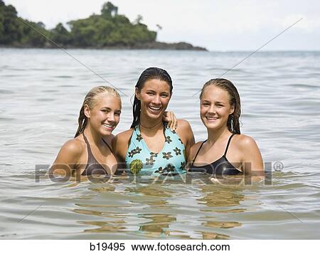 Stock Photography - three young women in the water. Fotosearch