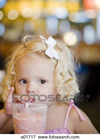 Stock Photo - Toddler girl drinking a strawberry milkshake.. Fotosearch
