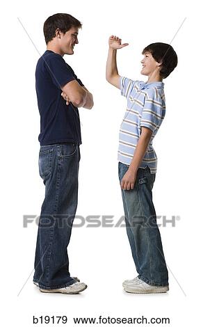 two brothers comparing height. View Large Photo Image Stock Photo - two brothers comparing height.. Fotosearch