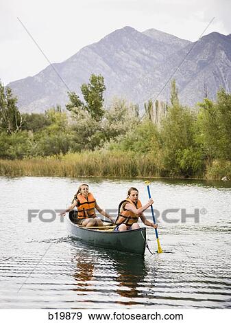 two girls in a canoe View Large Photo Image Stock Photo - two girls in a canoe. Fotosearch