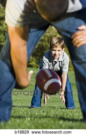 Stock Photo - Two people playing american football.. Fotosearch