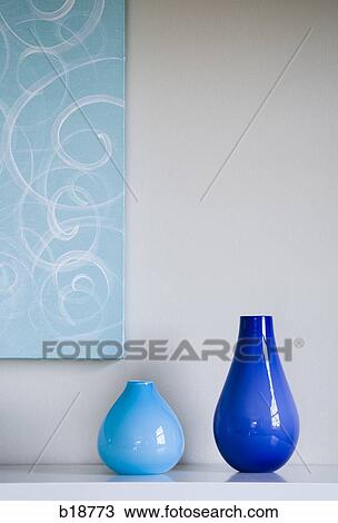 Two vases and a painting on the wall behind them. View Large Photo Image Stock Image - Two vases and a painting on the wall behind them.. Fotosearch