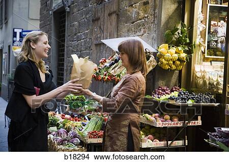 Two women at the market. View Large Photo Image Picture - Two women at the market.. Fotosearch