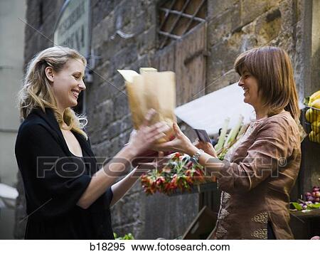 Two women at the market. View Large Photo Image Stock Photography - Two women at the market.. Fotosearch