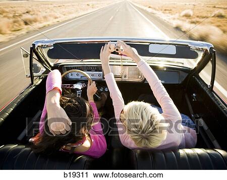two women in a red convertible View Large Photo Image Stock Image - two women in a red convertible. Fotosearch
