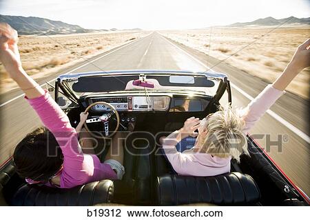 two women in a red convertible View Large Photo Image Stock Image - two women in a red convertible. Fotosearch