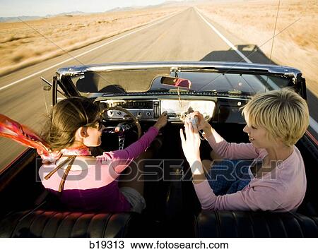 two women in a red convertible View Large Photo Image Stock Image - two women in a red convertible. Fotosearch