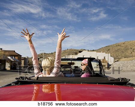 Stock Photograph - two women in a red convertible.. Fotosearch