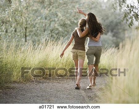 Two women on a nature walk. View Large Photo Image Stock Image - Two women on a nature walk.. Fotosearch