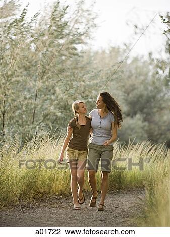 Two women on a nature walk. View Large Photo Image Stock Image - Two women on a nature walk.. Fotosearch