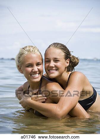two young woman in the ocean View Large Photo Image Stock Photograph - two young woman in the ocean. Fotosearch