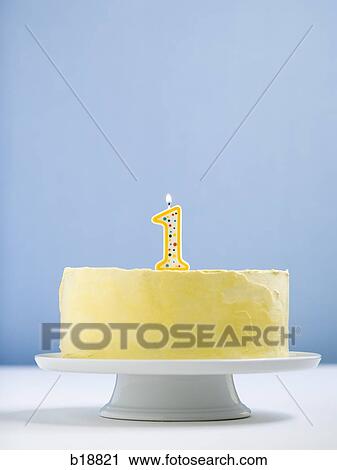 Stock Image - white cake on a platter with candles.. Fotosearch