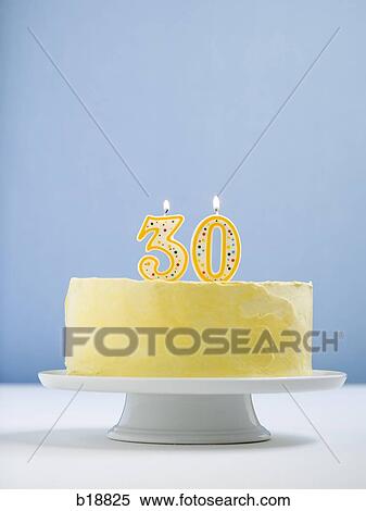 Stock Photography - white cake on a platter with candles.. Fotosearch