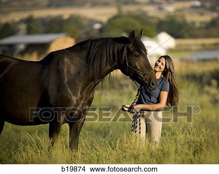 Picture - woman and a horse. Fotosearch