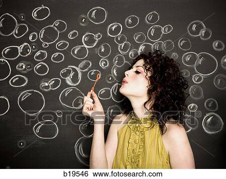 Stock Photograph - woman blowing bubbles. Fotosearch