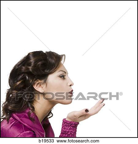 Stock Image - woman blowing kiss. Fotosearch