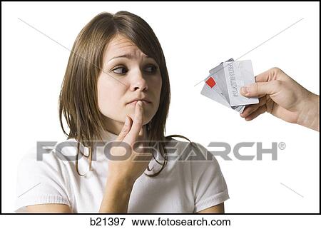 Stock Photo - woman choosing a credit card. Fotosearch