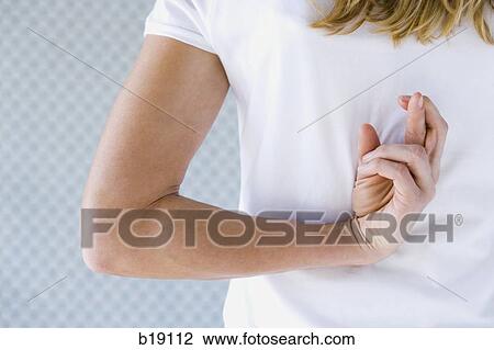 Stock Image - Woman crossing fingers behind her back.. Fotosearch