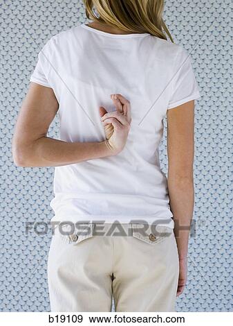 Woman crossing fingers behind her back. View Large Photo Image Stock Photo - Woman crossing fingers behind her back.. Fotosearch