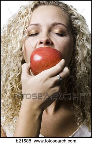 woman eating a red apple View Large Photo Image Stock Photo - woman eating a red apple. Fotosearch