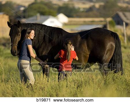 "woman, girl, and a horse" View Large Photo Image Stock Image - "woman, girl, and a horse". Fotosearch