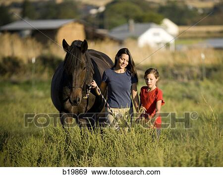 Stock Photo - "woman, girl, and a horse". Fotosearch