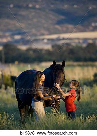 Stock Photo - "woman, girl, and a horse". Fotosearch