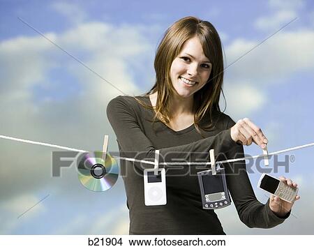 woman hanging electronics out to dry View Large Photo Image Picture - woman hanging electronics out to dry. Fotosearch